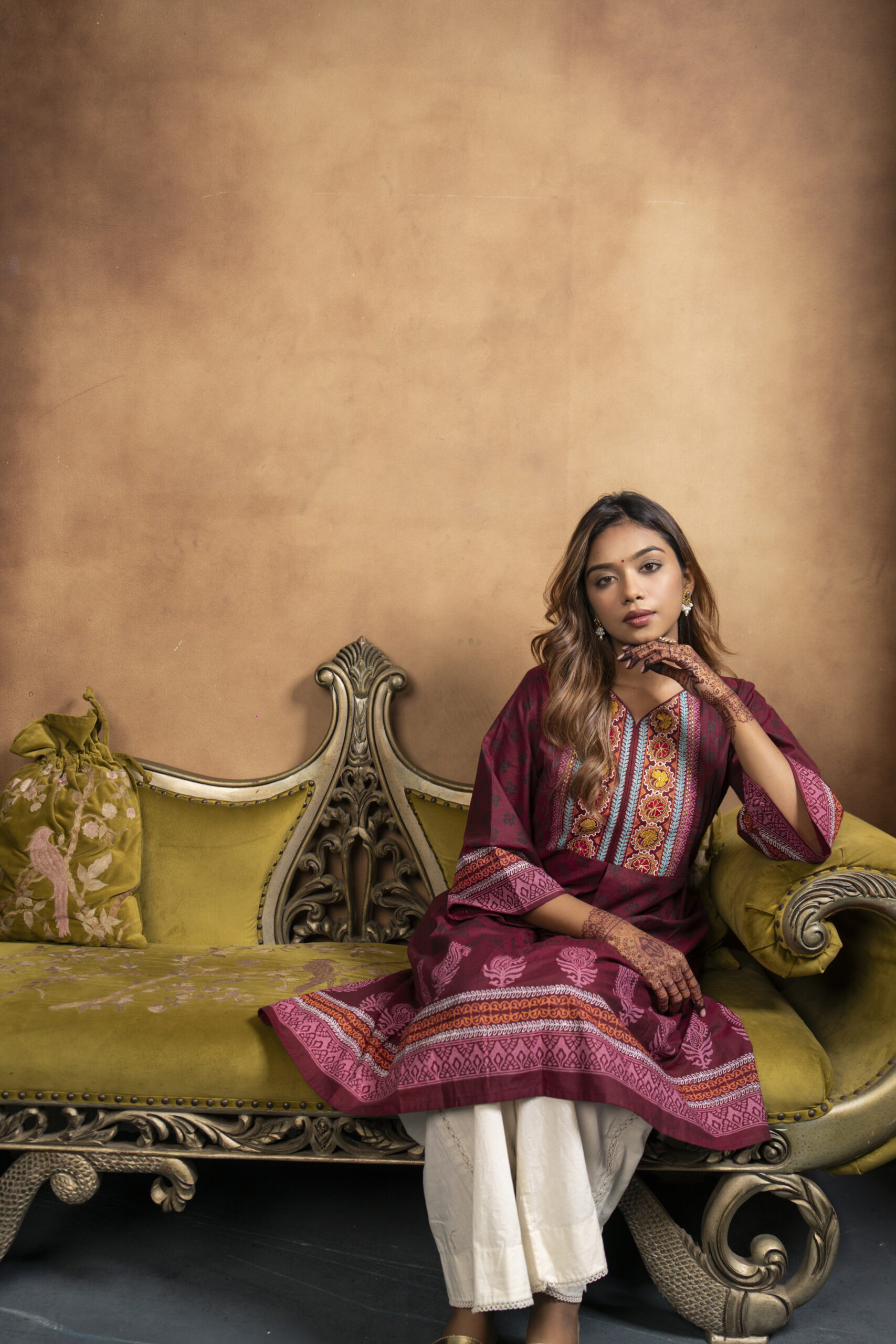 Phool Kurti It is a chambray cotton kurti, a model is posing in a studio setup