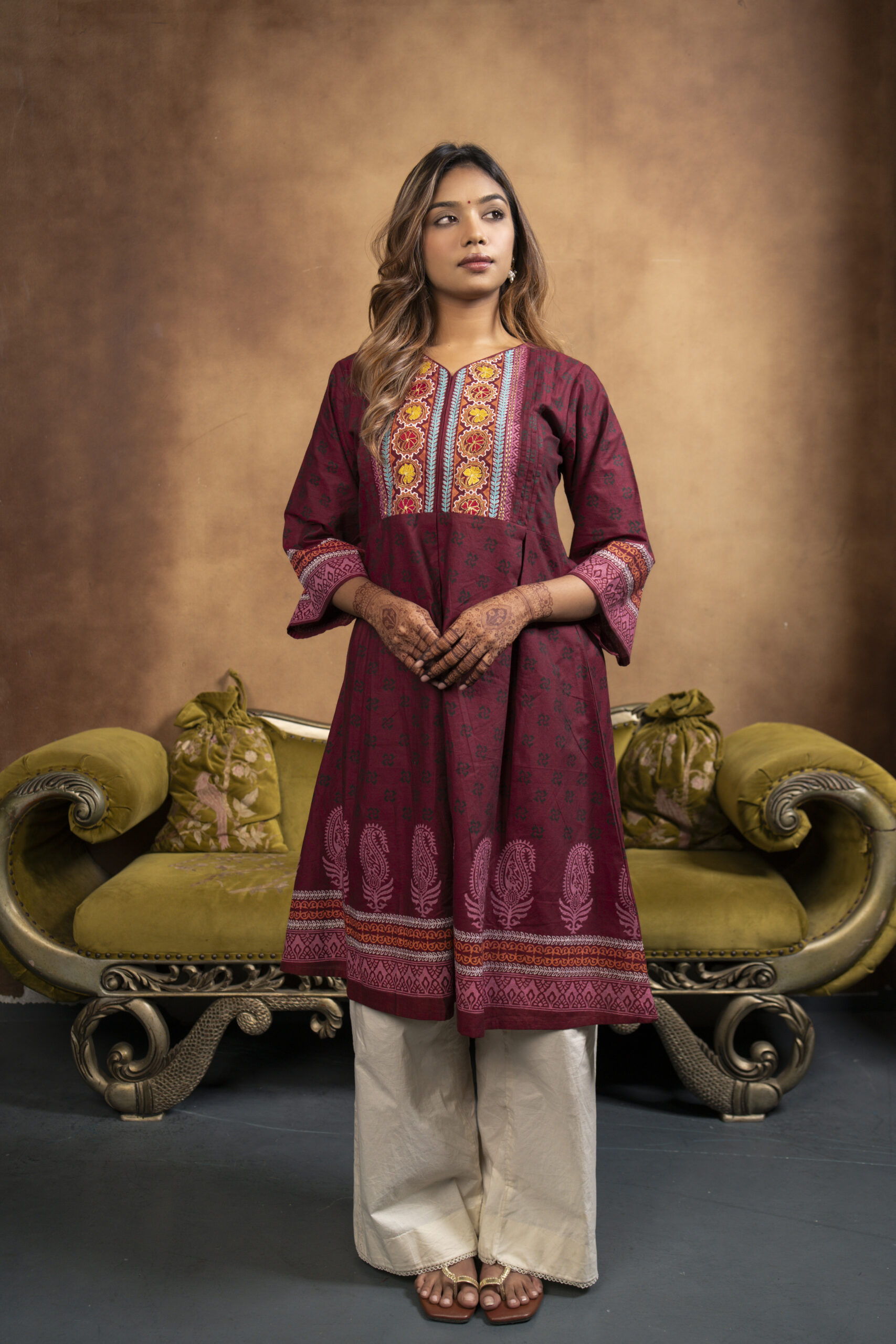 Phool Kurti It is a chambray cotton kurti, a model is posing in a studio setup