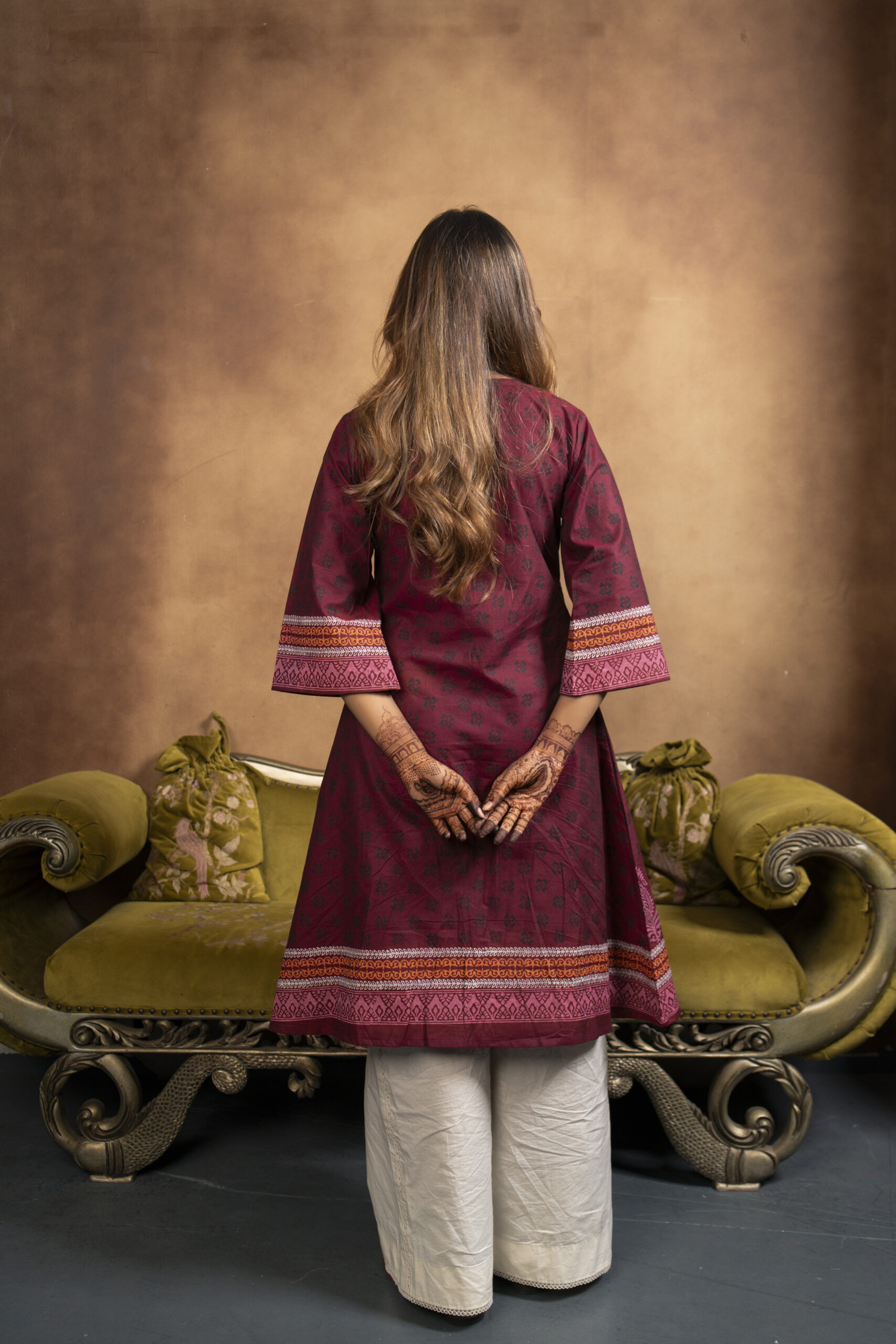 Phool Kurti It is a chambray cotton kurti, a model is posing in a studio setup
