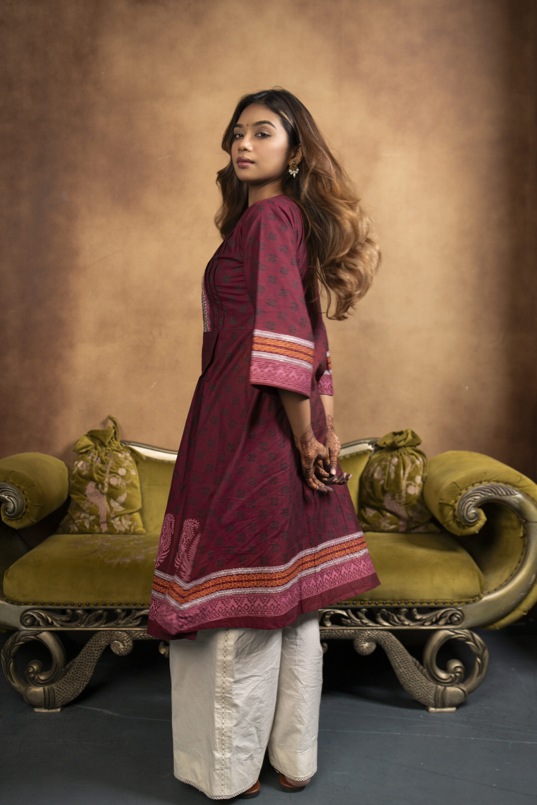 Phool Kurti It is a chambray cotton kurti, a model is posing in a studio setup